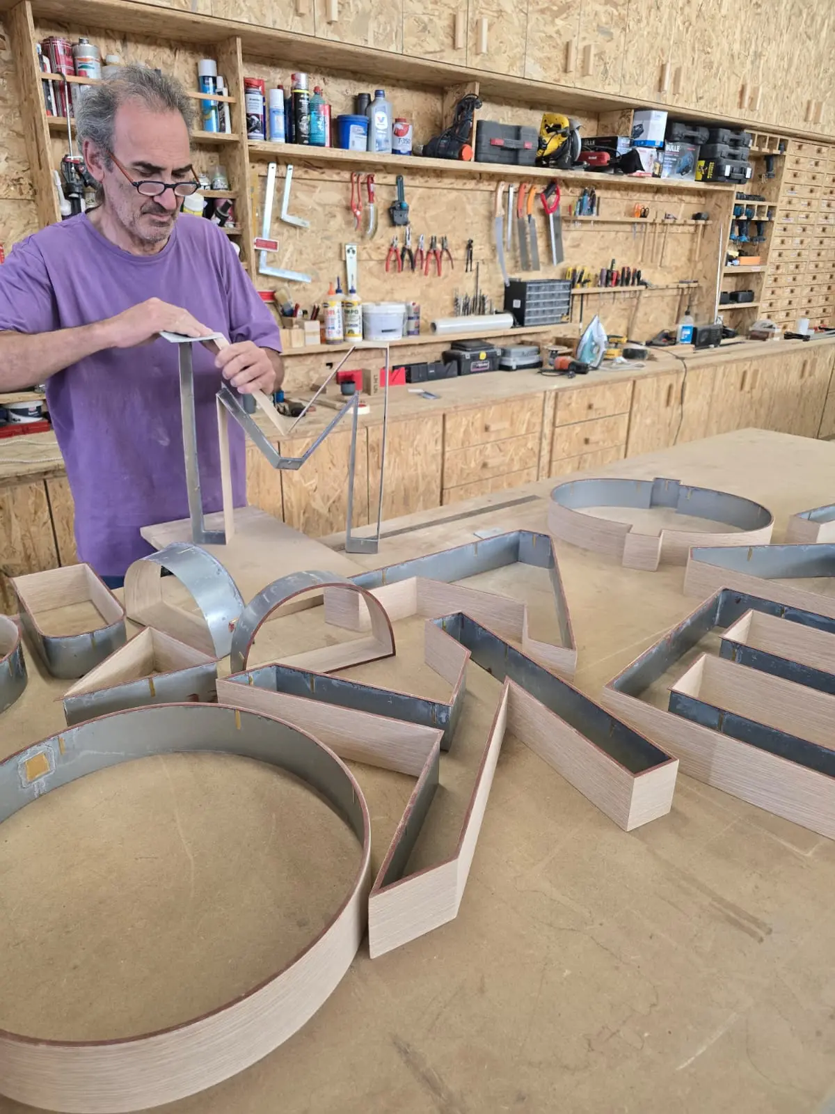 Custom wood veneer finish on metal lettering